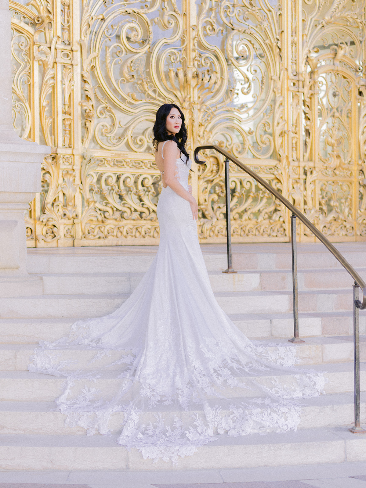 Bride posing in front of golden doors in Paris